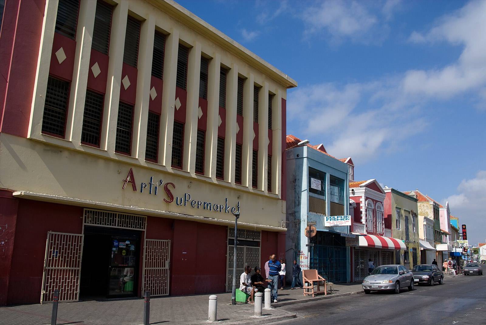 Shoppers passing the colorful storefronts of Breedestraat in Punda, Willemstad