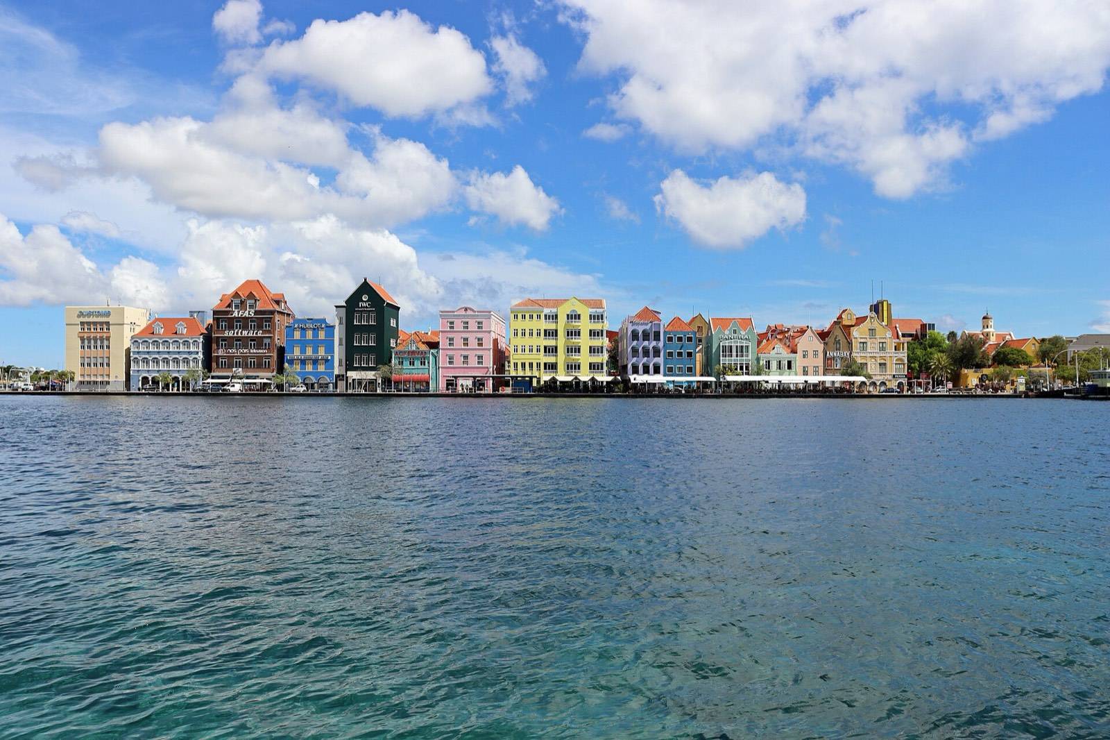 The gabled facades of the Handelskade in Willemstad as evening settles over the waterfront