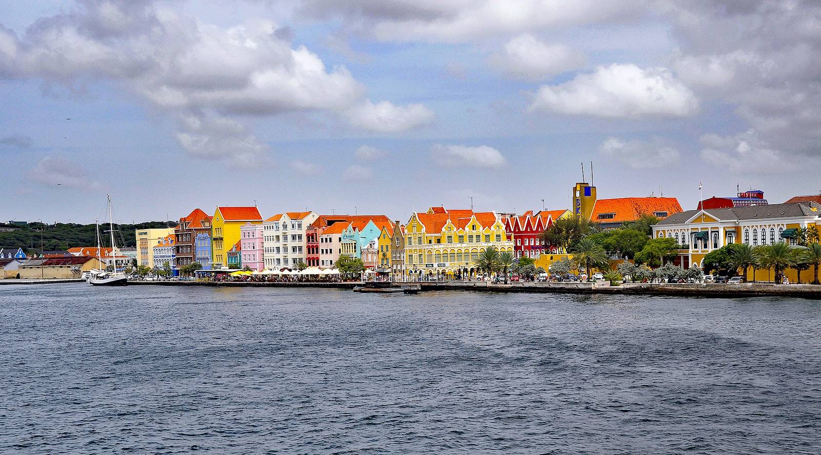 Elevated view over the rooftops of Willemstad toward the pastel waterfront of Punda