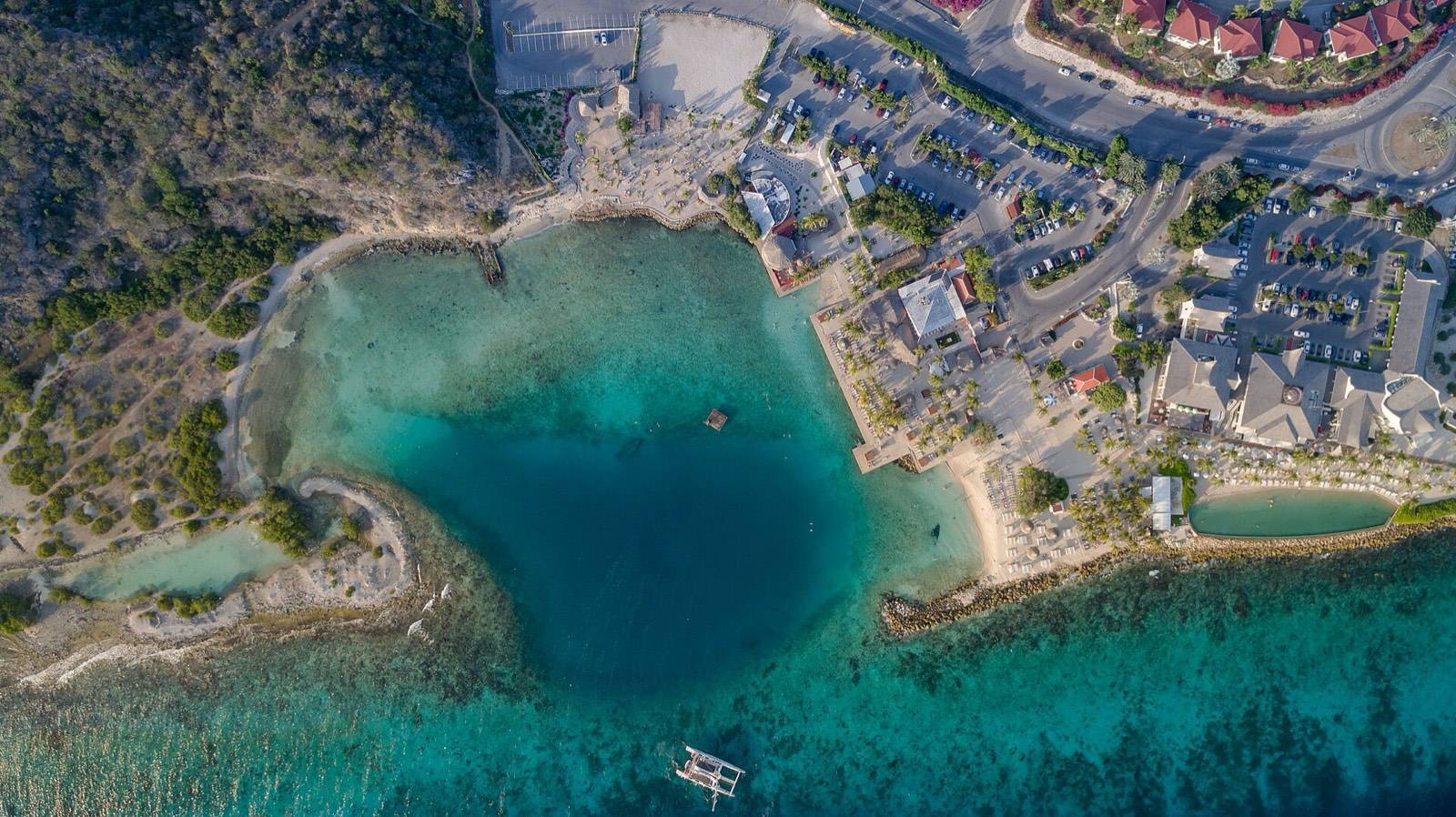 Beach club loungers beside the calm lagoon of Jan Thiel beach in southeast Curaçao