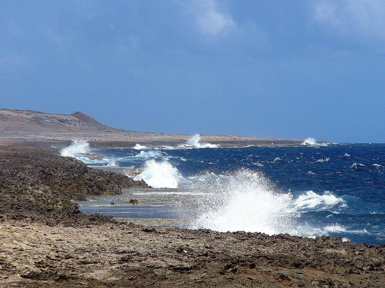 Waves breaking against the terraced limestone coastline of Shete Boka National Park