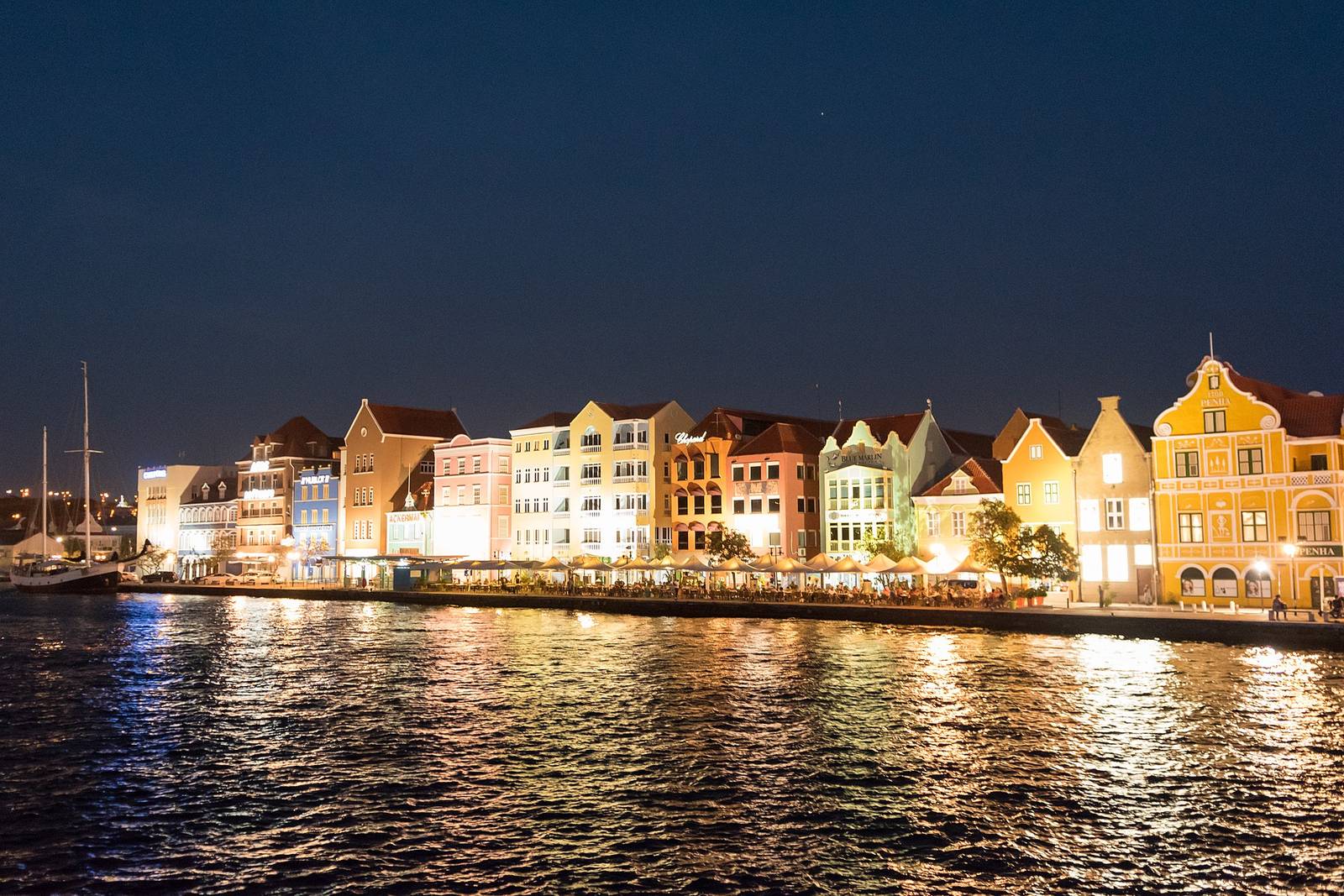 The Handelskade waterfront of Willemstad glowing after dark